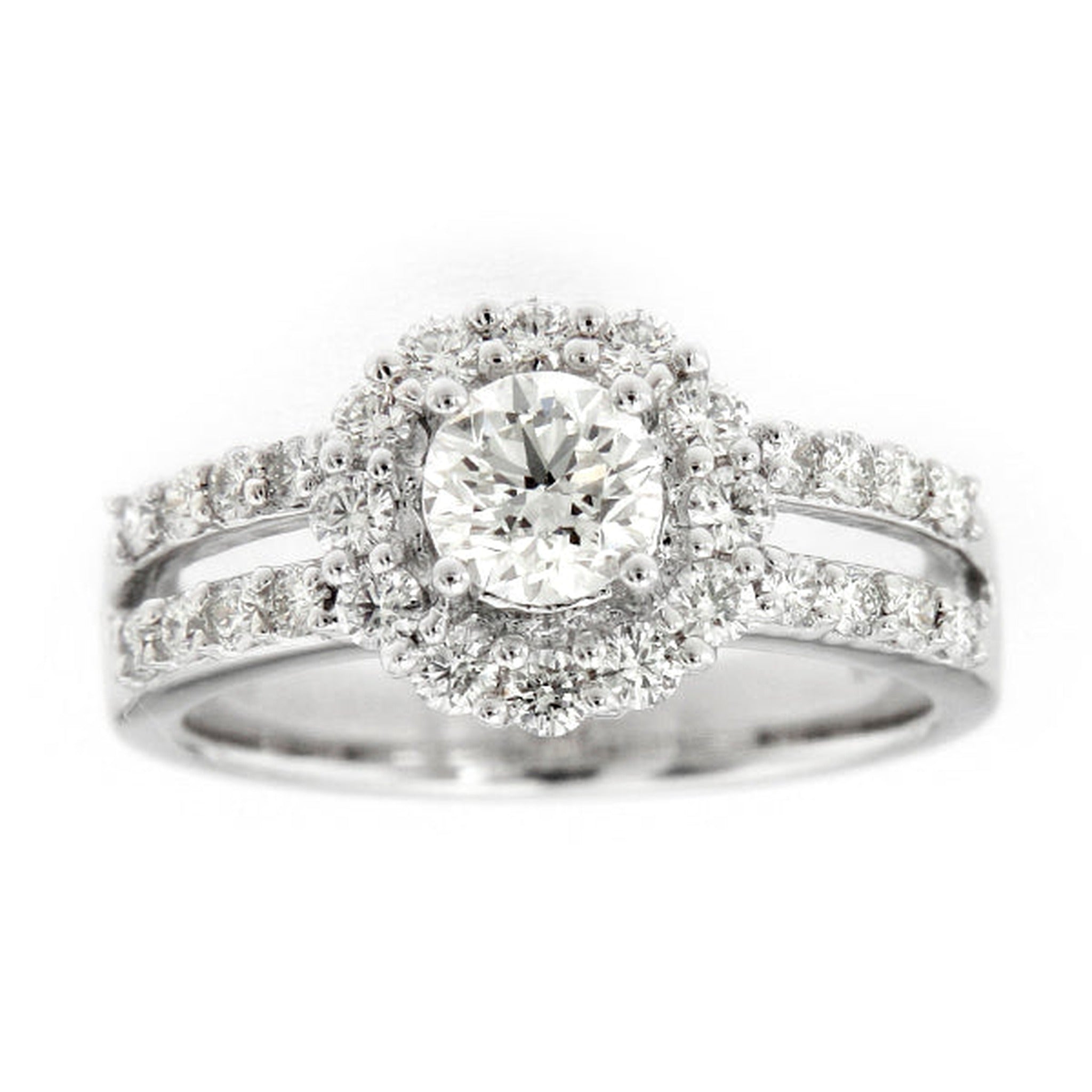 Platinum round brilliant diamond halo engagement ring by ISAAC WESTMAN® with sparkling central diamond and intricate setting.