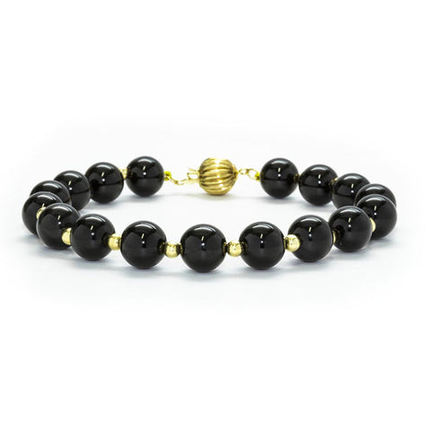 Polished 8mm black onyx and 14K yellow gold bracelet by ISAAC WESTMAN®, featuring smooth black onyx beads and gold accents.