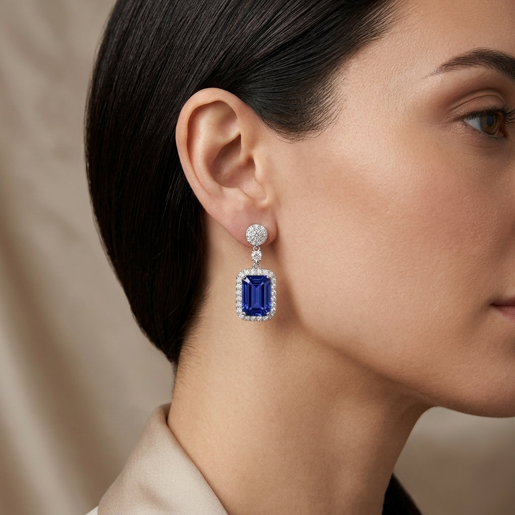 Model wearing ISAAC WESTMAN tanzanite and diamond drop earrings in 18K white gold