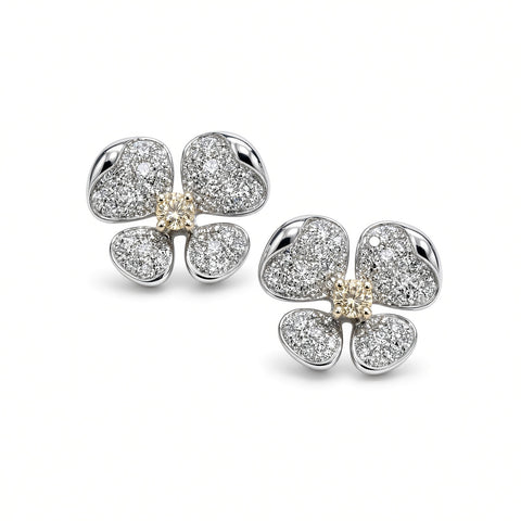 Pair of pavé diamond flower earrings with yellow diamond centers on white