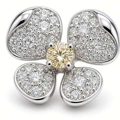 Close-up of a diamond flower earring showing pavé petals and a four-prong yellow diamond center