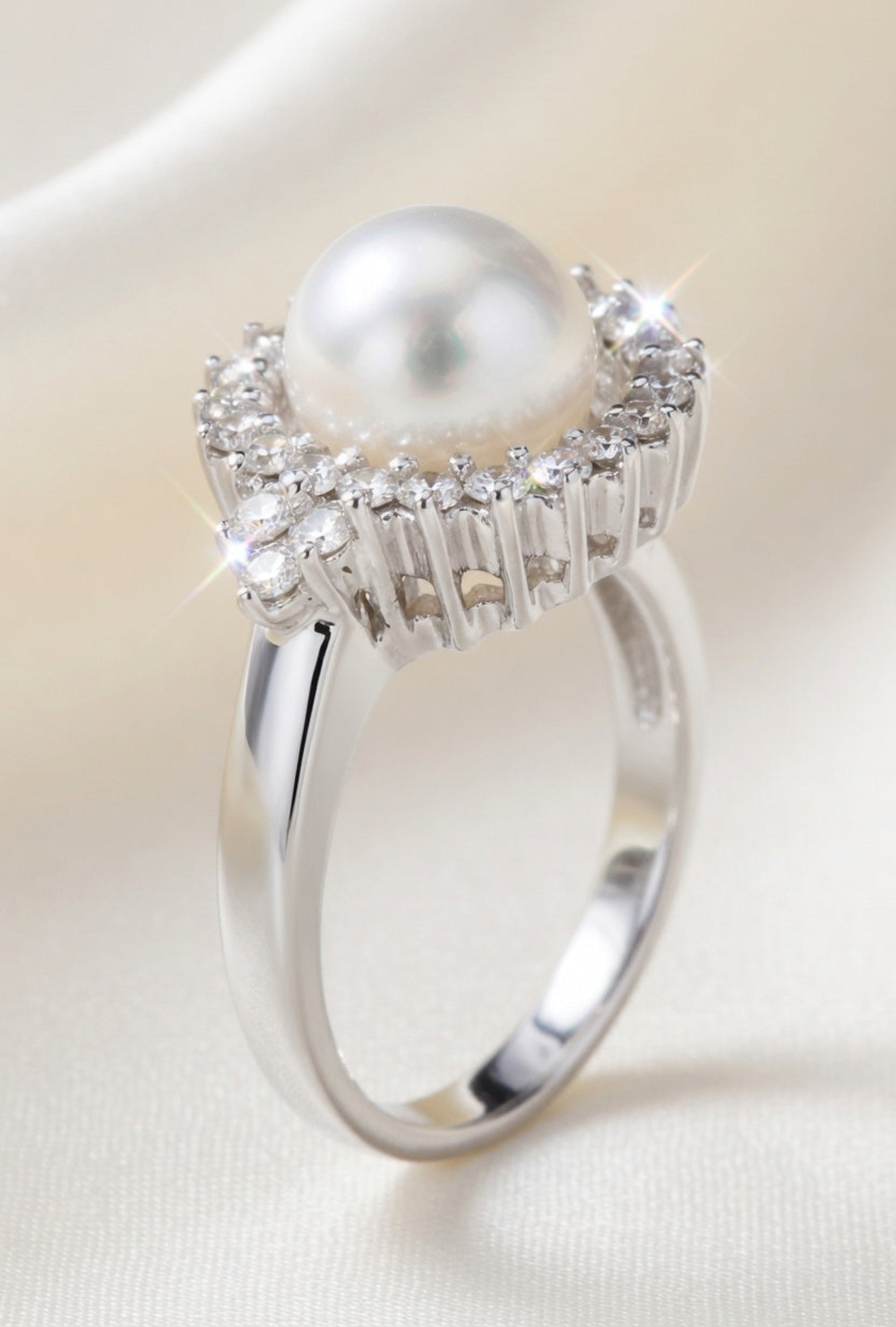 Diamond and pearl ring by ISAAC WESTMAN® featuring a sparkling diamond and elegant pearl setting on a silver band.