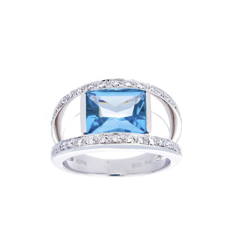 Gold ring with a central blue topaz gemstone and diamond accents, crafted by Isaac Westman.