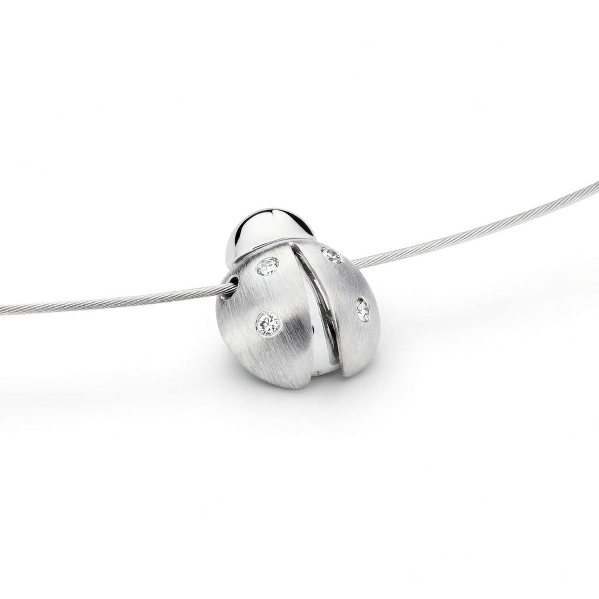 White gold and diamond ladybug pendant by Isaac Westman, featuring a detailed ladybug design with sparkling diamonds.